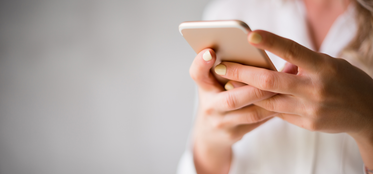 hands texting on a cell phone